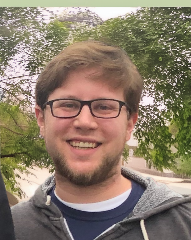 Young man smiling wearing glasses