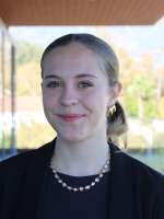 Girl, named Adeline, with gold necklace and earrings